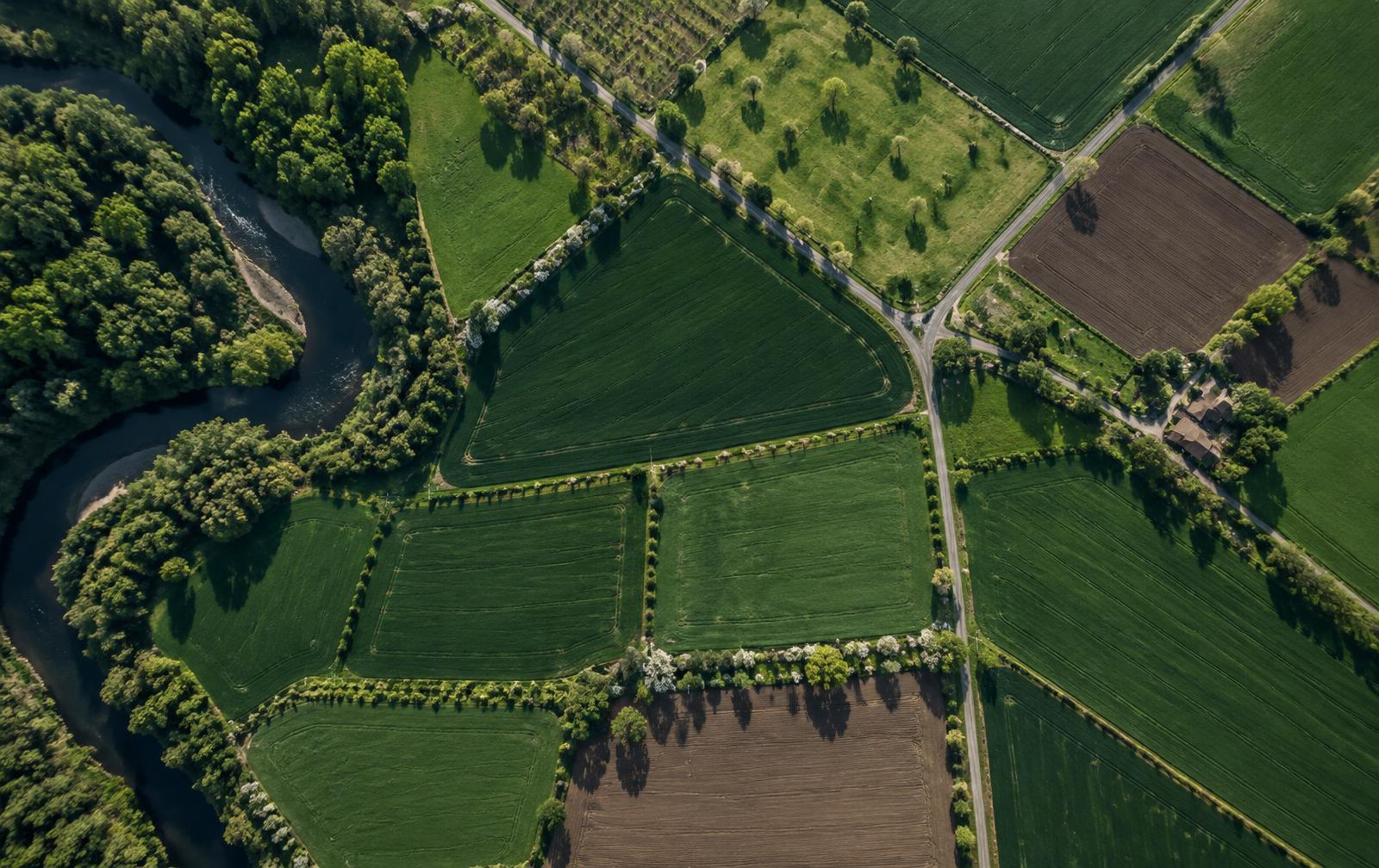 Aerial view of fields, roads, and river systems